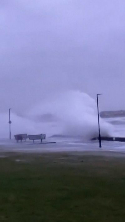 A large wave seen battering the coastline