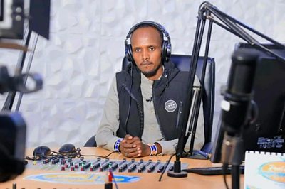 Wambaz presenting his radio show on Radio Jangwani in Marsabit County