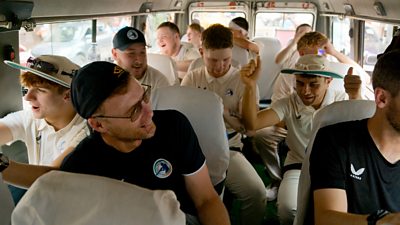 Interior of a crowded bus with Freddie and a group of boys