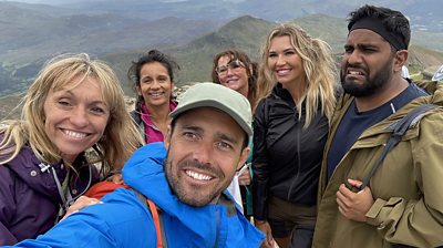 Eshaan, Amanda, Christine, Michaela, Sonali and Spencer do a windy selfie on a mountain