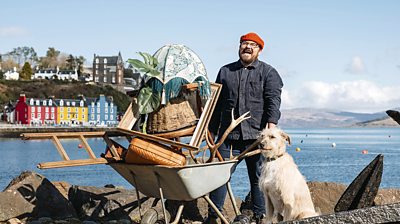 Banjo Beale and Grampa the dog in front of water and mountains