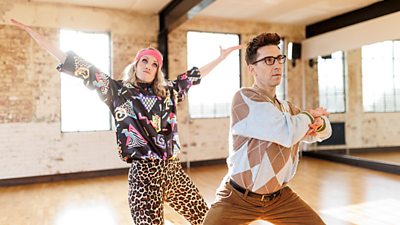 Rachel Parris and Russell Kane in a mirrored dance studio throwing some shapes