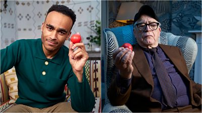 Left - A young man sits on a sofa holding a red nose. Right - An older man sits in an armchair holding a red nose.