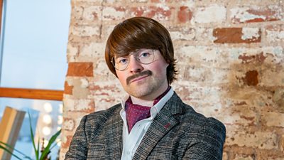 Nigel - comedian Paddy Raff's posh alter ego wearing a tweed jacket, white shirt and red silk cravat. He also sports a moustache