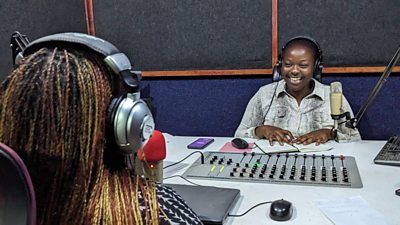 Womba interviewing guest in the studio