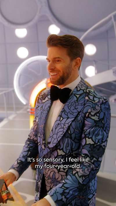 Joel Dommett aboard the TARDIS, he is playing with the buttons and exploring the ship.