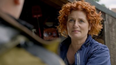 Woman with red hair wearing a blue jacket