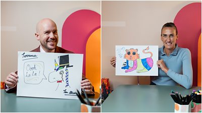 Tom Allen and Jill Scott sat showing off their pen drawings. Tom's is of a unicorn wearing a bow tie and a top hat, and Jill's is of a colourful lioness.