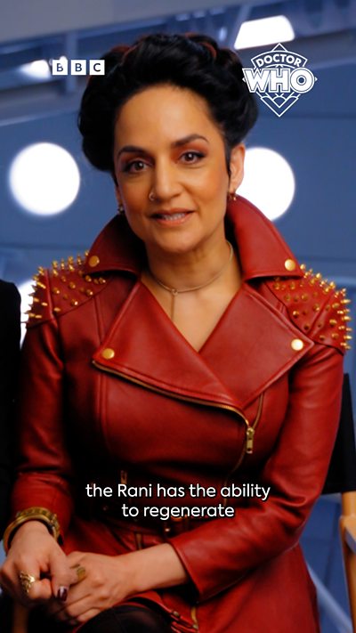 The Rani from Doctor Who, she is wearing a red coat with spikes on the shoulder pads.