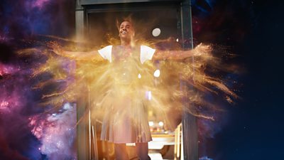 The doctor is held at the door of Tardis in space, regenerating