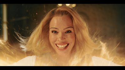 A blonde woman smiles as her face emerges by regeneration energy