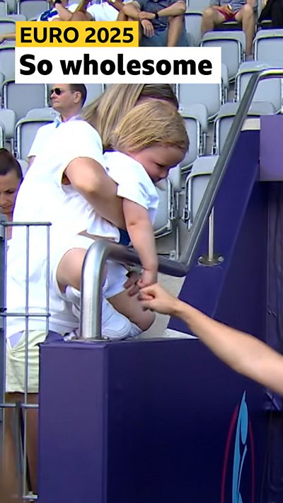 Baby football fan fist bumping players