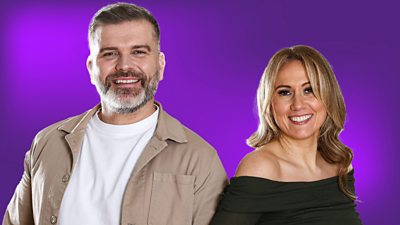 A man and a woman smiling against a purple background