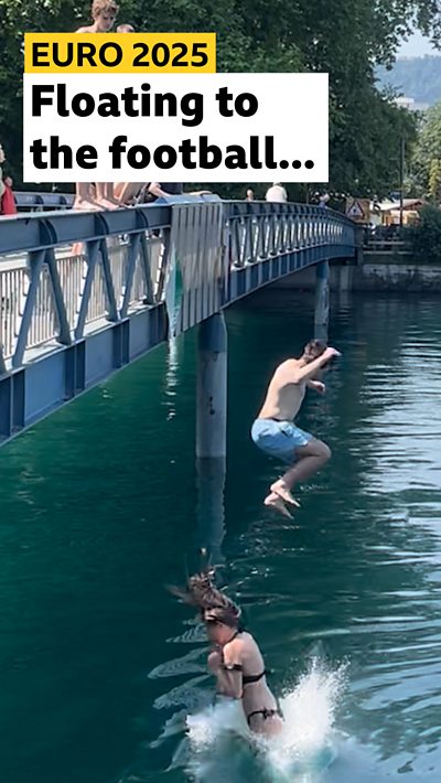 People jumping into a river in Bern, Switzerland