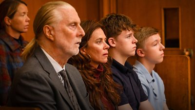 Five characters - male and female - sat in a court of law, listening , with shocked looks on their faces