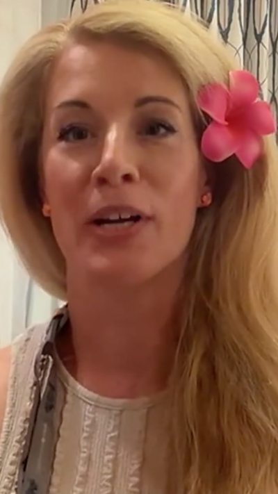 Rachael Burrows wearing a large pink flower in her hair