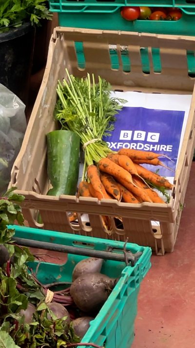 A box of vegetables with a BBC Oxfordshire logo.