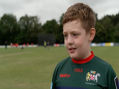Boy in green shirt who attended the Cricket Connects camp