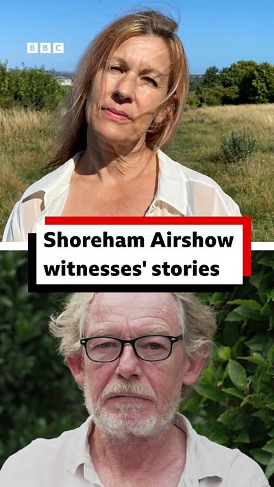 A woman with blonde hair in a white top and a man in a white shirt with white hair and glasses look into the camera.