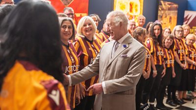 His Majesty King Charles laughs with Bantam of the Opera choir members at Cartwright Hall