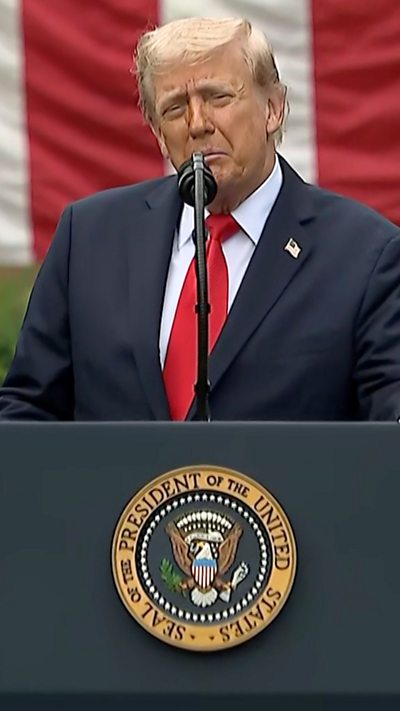 President Trump stands behind a podium outside the Pentagon wearing a blue suit, red tie and white shirt.