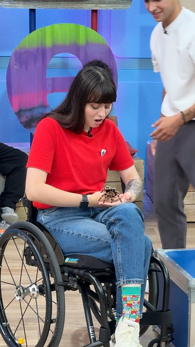 Abby holds a tarantula.