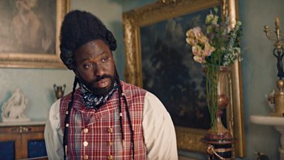 A man in period clothing looking at something out of shot. His surroundings are inside a period building and very ornate, such as ornaments and a tall vase of flowers.