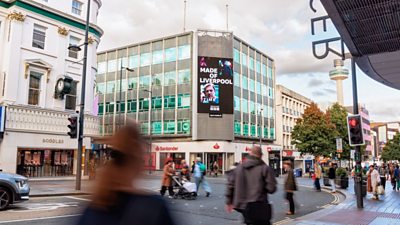 Made in Liverpool artwork on the side of a building in a busy shopping street. The Radio City Tower is in the background.