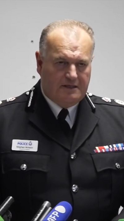 Chief Constable Sir Stephen Watson in uniform as he reads a statement