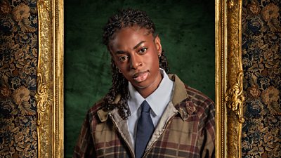 A woman in a shirt, tie and tartan jacket looks to camera with her head slightly tilted to the side. Her portrait is contained with a gilded frame.