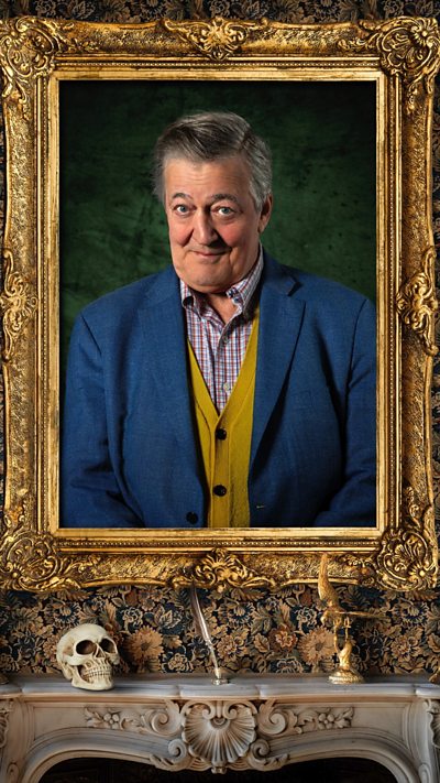 A portrait of Stephen Fry - in a blue suit jacket, yellow cardigan and checked shirt - is in a gold frame on a wall