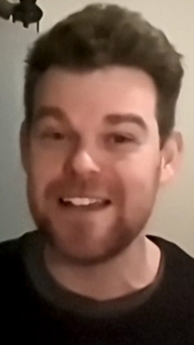 A close-up of Ivan Brett wearing a black jumper during a zoom interview