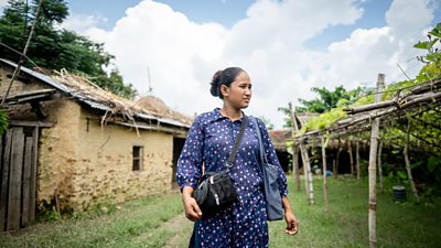Bindu Chaudhary, stands in a village in Nepal, she is a 30-year-old producer at Gurbaba FM and a flood survivor