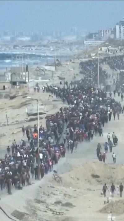 A line of people trails into the distance