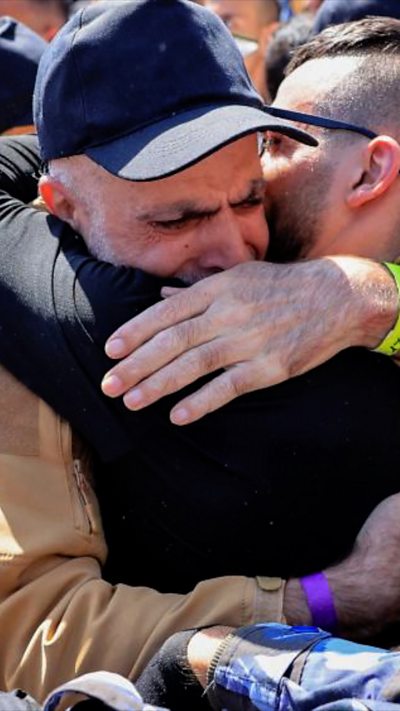 A Palestinian freed prisoner embraces another man in Ramallah, Palestine.
