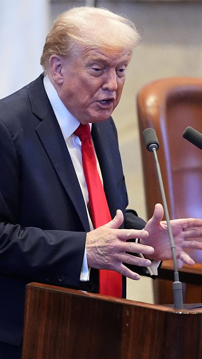 Donald Trump speaking at a podium in the Knesset