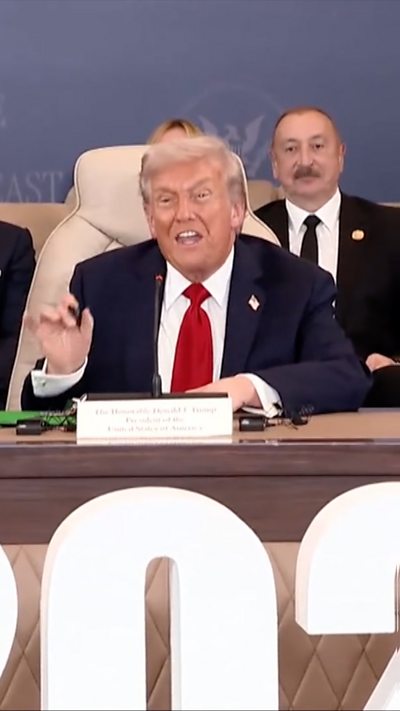 President Trump holds a pen and speaks at the signing ceremony in Egypt