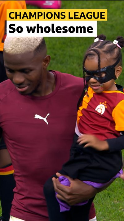 Osimhen's carries his young daughter who is wearing a black sport face mask