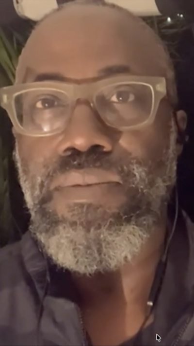 BBC reporter Nick Davis wearing glasses and blue shirt