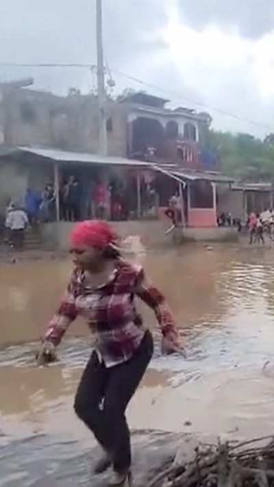 Woman walking through flooding