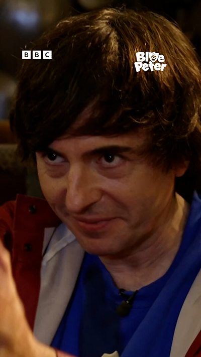 Danny Robins looks mischievous and spooky.
