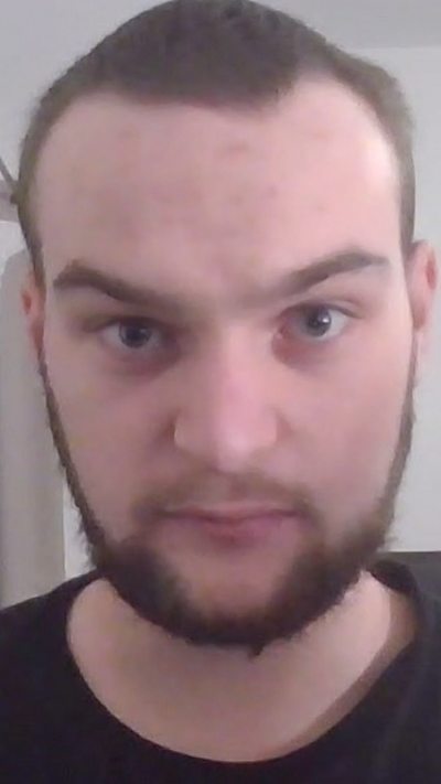 Thomas McLachlan, wearing black t-shirt, speaking