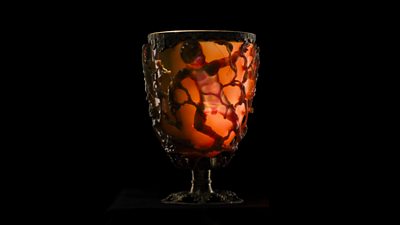 A Lycurgus Cup sits in front of a black background