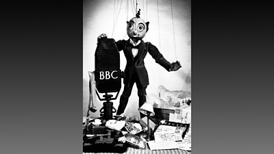 Mt Turnip with his postbag of letters alongside a classic BBC microphone.