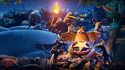 A robin, some mice and a pigeon gather around a mince pie on a snowy night while a cat lurks in the background