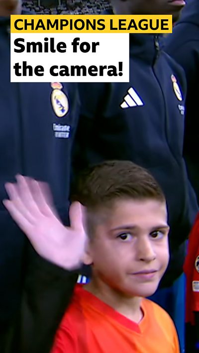 Child mascot waving