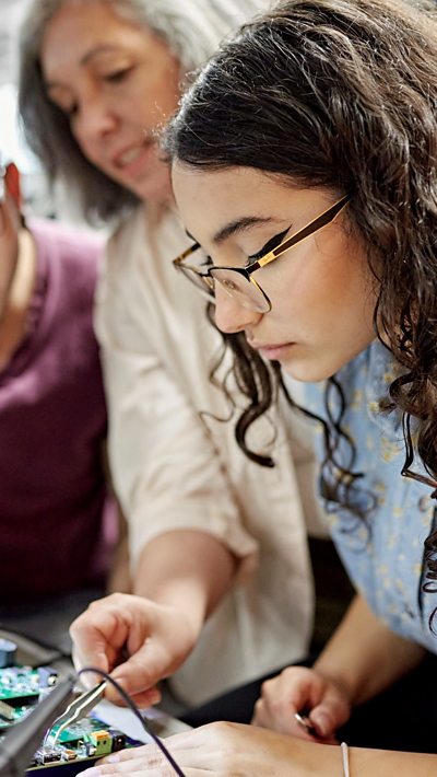 An older woman training a younger woman