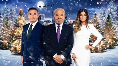 Two men in a suit and a woman in a white dress pose in front of a snowy setting