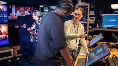 Blue Room staff demonstrating AI technologies online via touchscreens, and the latest Smart TV technologies, to various BBC colleagues