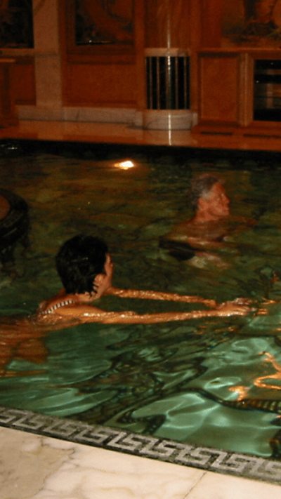Bill Clinton is seen in the swimming pool with Ghislaine Maxwell.